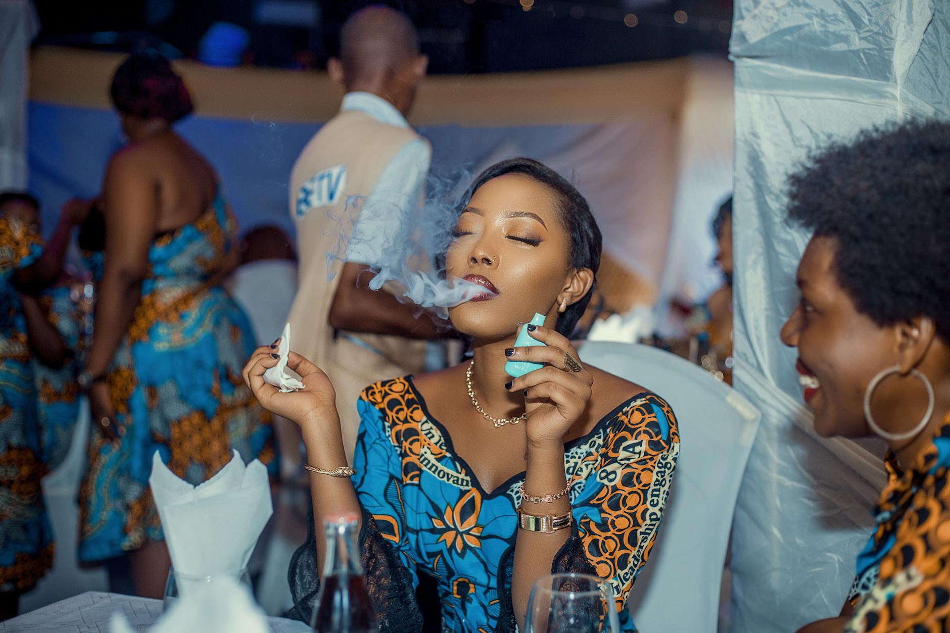 elegant woman smoking at vibrant party